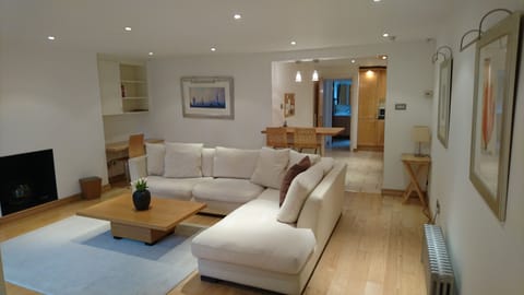 Spacious front room leading to breakfast bar and modern kitchen.