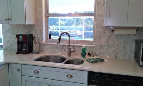 Stainless steel sink with high spot faucet and sprayer,