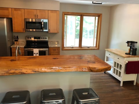 Live edge bar separates kitchen and dining area.