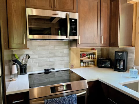 Brand new appliances, well stocked with spices.