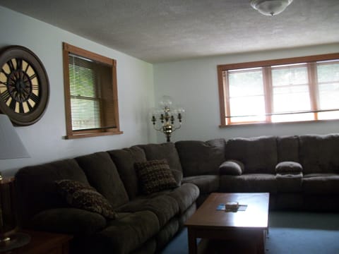 living room with large reclining sectional and big flat screen tv. Cable & wifi