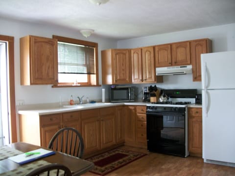 large eat-in kitchen with half-wall open to living room
