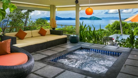 Open-plan living area with jetted plunge pool and ocean views of the islands

