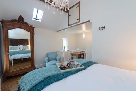 large and airy bedroom - with writing table at top of stairs 