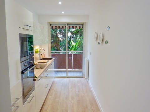 The kitchen opens onto the rear balcony too.