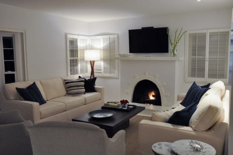 Spacious living room with two large couches and comfortable sitting chairs. 