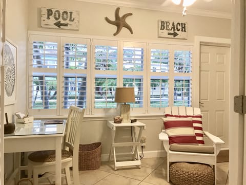 The sunroom with a view of the tropical boulevard.
