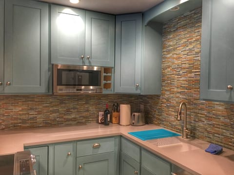 Newly remodeled kitchen with stainless steel appliances and quartz countertops.