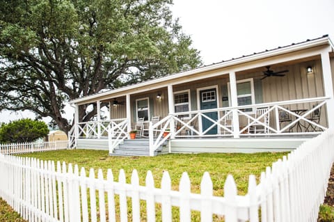 The Country House: a 3/3 with a big porch and fenced yards, front and back