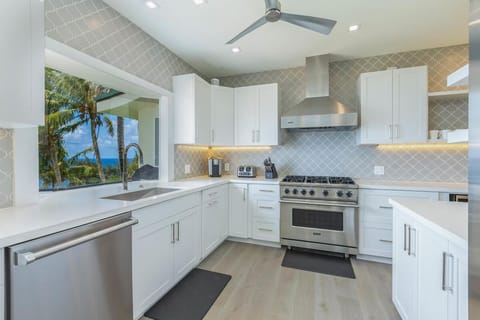 The gourmet kitchen features high-end appliances and a stunning view from the sink.