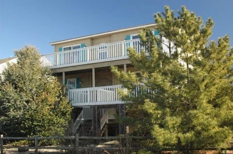 Front of house with upper and lower decks facing bay