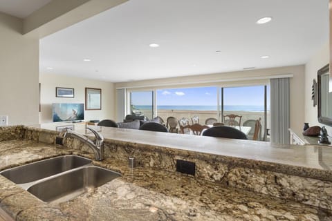 The kitchen looks out onto the main living and dining area, making meal prep a social affair!