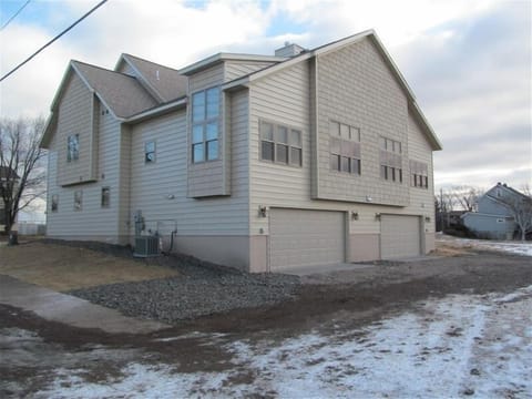 back of house with garage entry and driveway