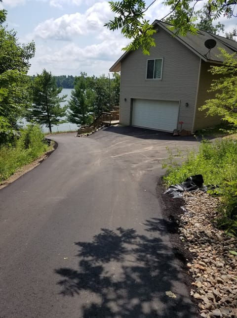Paved driveway. Two car garage with parking available on the side of the house.