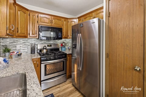 Gas stove and side by side refrigerator freezer with ice maker