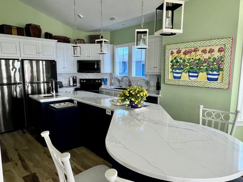 The sunny kitchen offers two refrigerators and two dishwashers.  