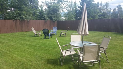 Private back yard with fire pit and outdoor seating.