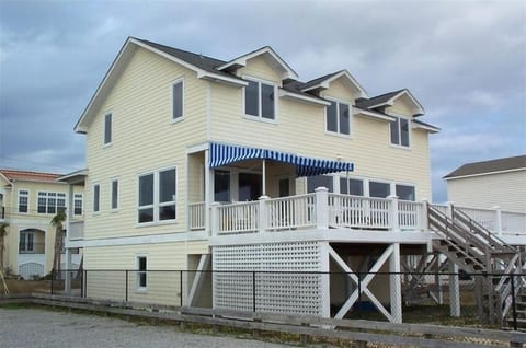 The ocean side of the house has windows with breathtaking views and a large deck