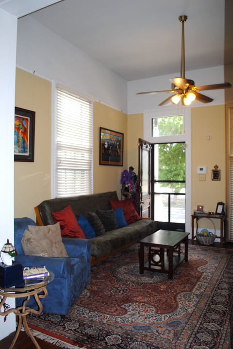 Den area with comfy queen futon sofa bed and armchair for relaxing and TV time.