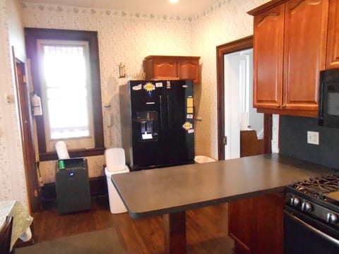 Different kitchen view.  Refrigerator side-by-side upper doors, bottom freezer