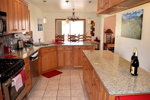 Open plan kitchen with granite counter tops and stainless appliances
