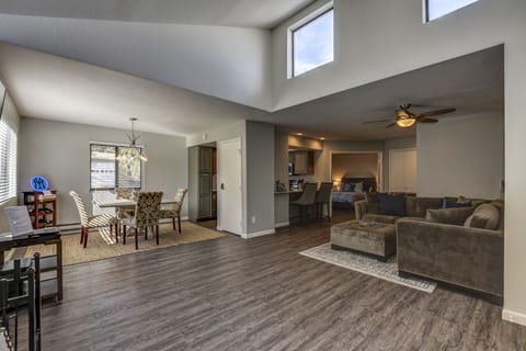 Living Room/Dining Area with vaulted ceilings and an abundance of natural light 