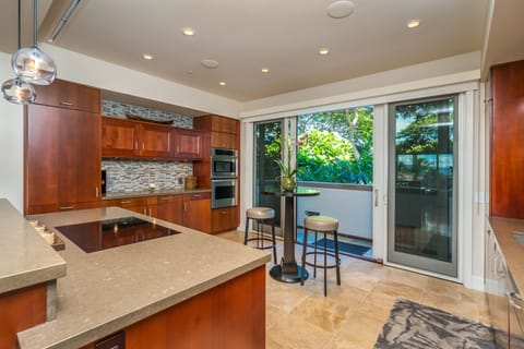 Tree house like views across the outdoor rear dining lanai.Full glass backsplash