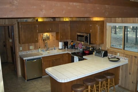 New appliances in well equipped kitchen.  4 barstools at island