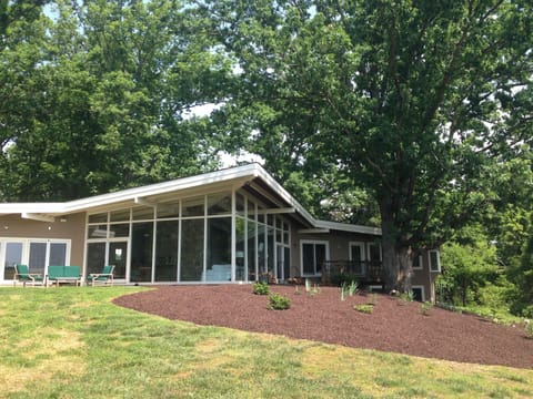Rear view featuring large patio and 'wall of glass' for indoor/outdoor living