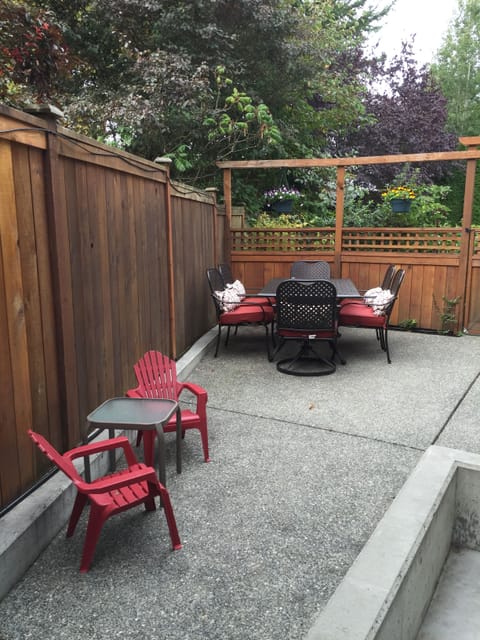 Fully fenced, private patio with seating and BBQ.