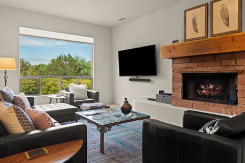 Living area featuring gas fireplace and 70" TV