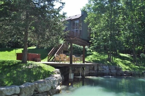 Scenic view of pond, deck/pier and back of the house.