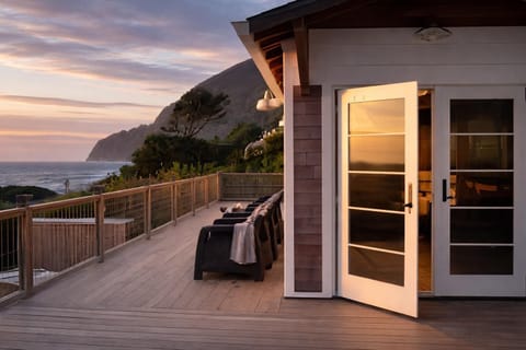 Perched above the shoreline—relax on the deck with wide Pacific views
