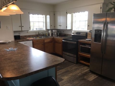 Fully equipped kitchen with large bar for serving meals.  