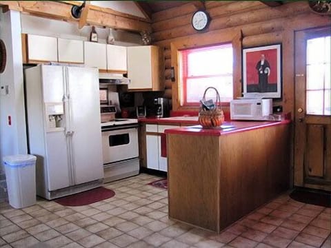 The Hunting Lodge: featuring a fully stocked kitchen with dining area.