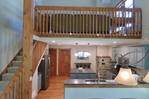 View of downstairs kitchen and upstairs loft