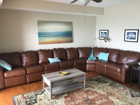 Large open concept living room with lake view and balcony access