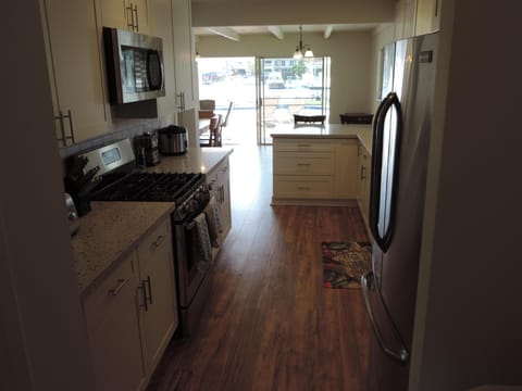 Looking out kitchen to dinning room then pool