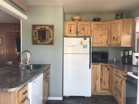 Full kitchen complete with towels, utensils, cookware, microwave, and dishwasher