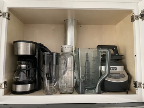 Extra coffee maker, water jugs and blender. 