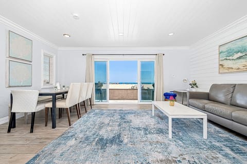 Sliding doors open from the main living area out to the front patio, boardwalk, and beach beyond!
                