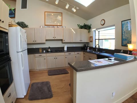 Kitchen sits off dining room and overlooks deck w/2 lounge chairs/1st Fairway.