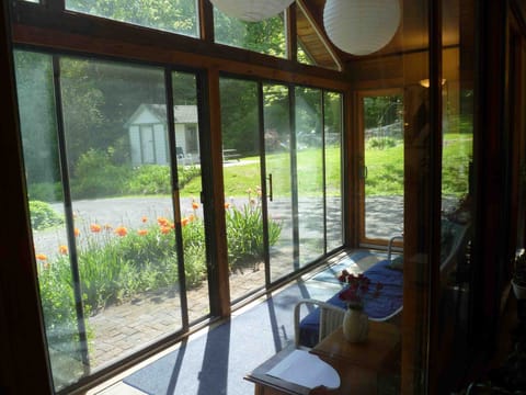 Colorful poppies-view from the screened sun porch onto patio, gardens and woods.