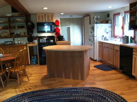 Charming kitchen area with island and dishwasher.Great views of backyard & woods