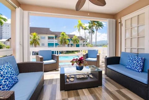 Porch overlooking pool with a view of water