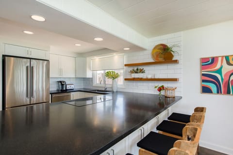 Prepare fresh island meals in this sleek, updated kitchen with ocean views, ample counter space, and bar seating for casual breakfasts.
