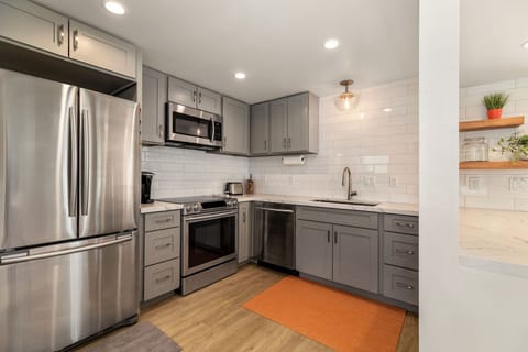 Fully equipped guest house kitchen with stainless steel appliances and modern finishes—ideal for extended stays.