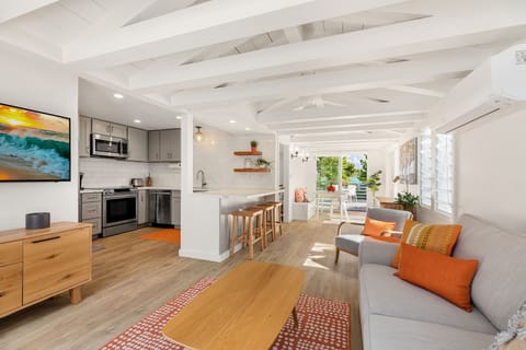 The guest house living room is bright and beachy, featuring open-beam ceilings and a full kitchen—perfect for privacy and comfort.