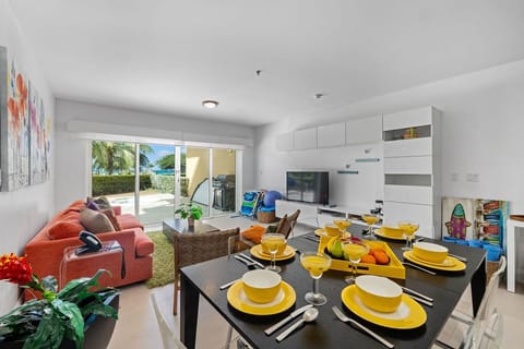 Relax in your bright, modern living space, where tropical breezes meet comfort. Dine together at a cheerful table, unwind on the sofa, and step outside to paradise.