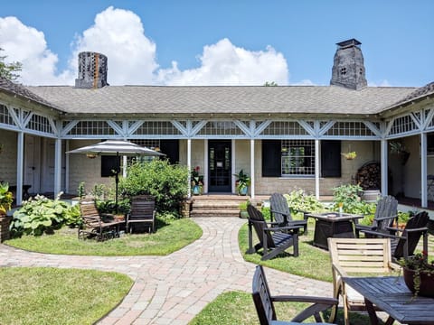 Exterior Courtyard, Adirondack chairs, shade umbrella and propane fire table